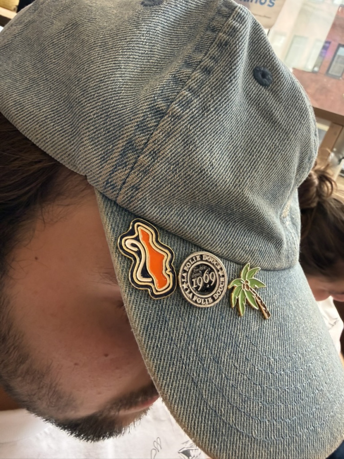 Lustrum logo as an enamel pin on a cap
